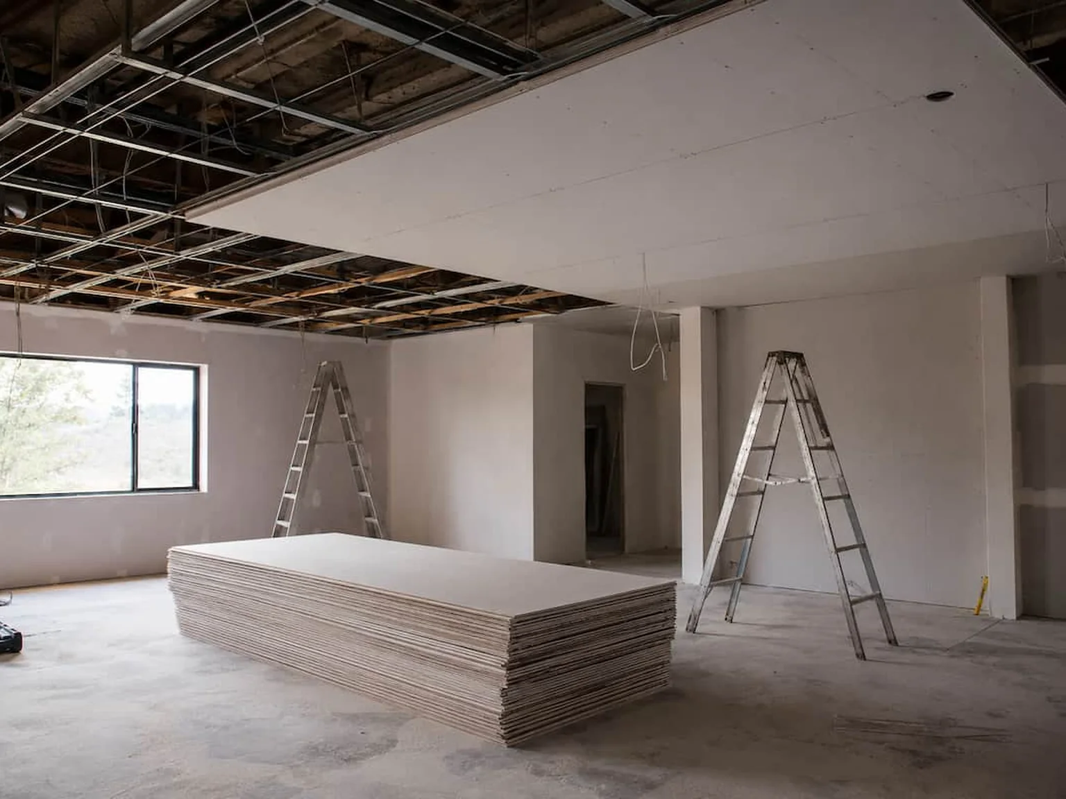 A Perth room stripped back for a ceiling replacement, new sheets stacked and ready to go up