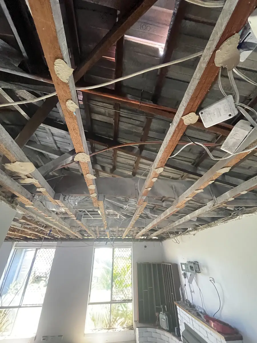 Old living room ceiling taken down to the timber frame and wiring in a Joondalup home