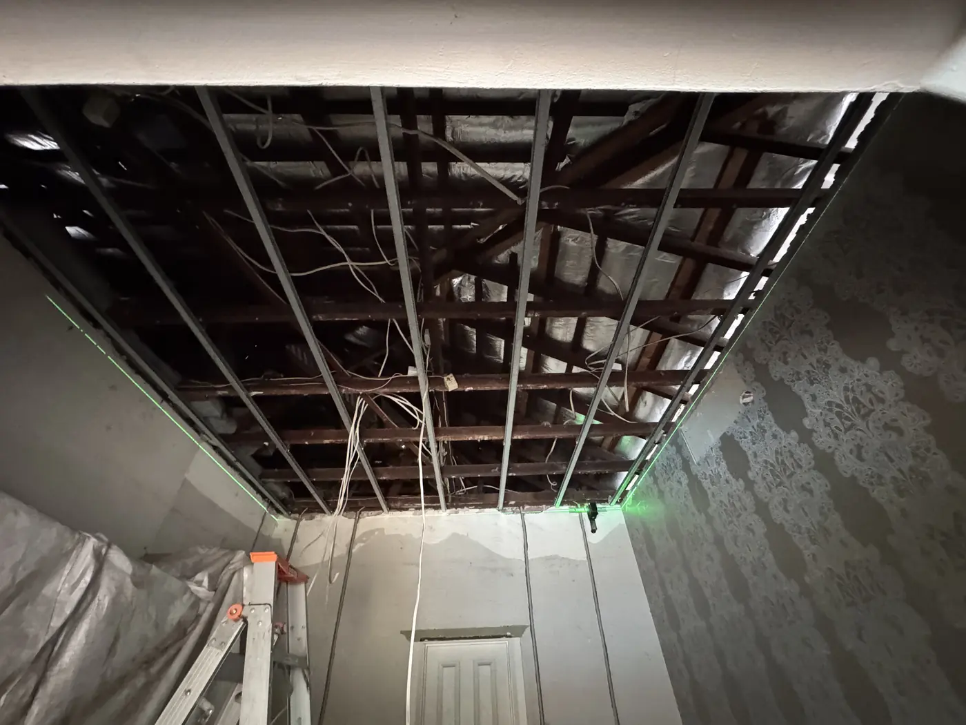 Old ceiling fully removed in a Mount Lawley room, with the roof timbers on show
