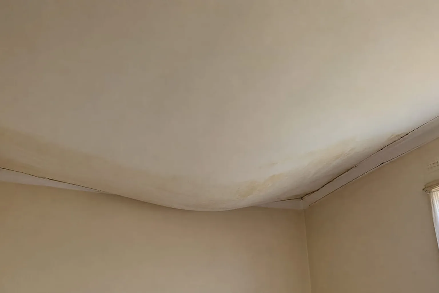 A plasterglass ceiling bowing down away from the joists in a Perth home